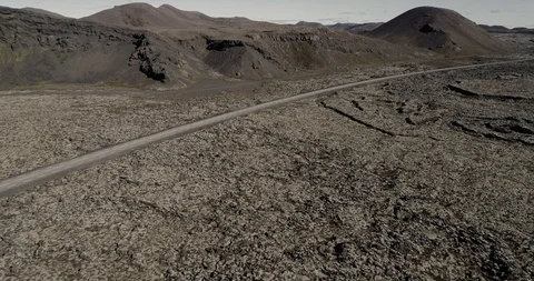 Car driving on road going through lava field in Iceland Stock Footage 95641645