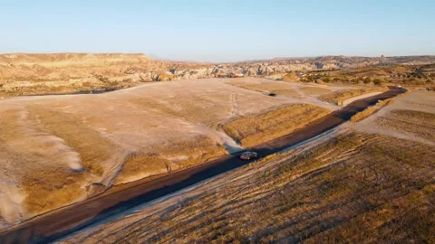 Car driving on road, high-angle drone tracking shot, Video stock 252648689