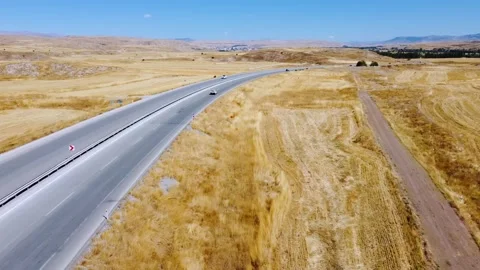 Car driving on road, high-angle drone tracking shot, Stock Footage 252655528