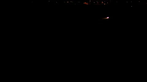 Car driving on a road at night Stock Footage