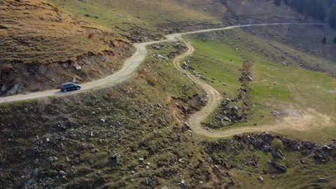 Car driving on a road through the mountains Stock Footage 160213397