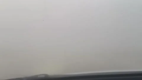 Car driving on road through thick dense fog with low visibility Stock Footage 333613446