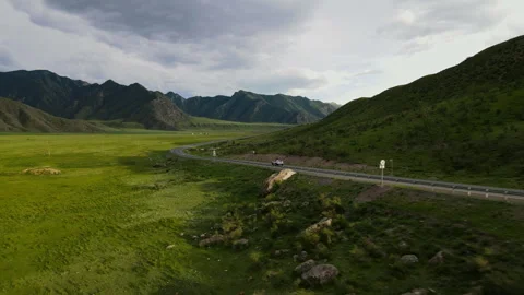 Car is driving on the road with a view of the mountains Stock Footage 246591112