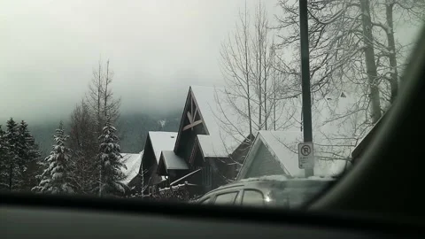 Car Driving In Small Town Covered In Snow 4K Banff Canada Stock Footage 239169220
