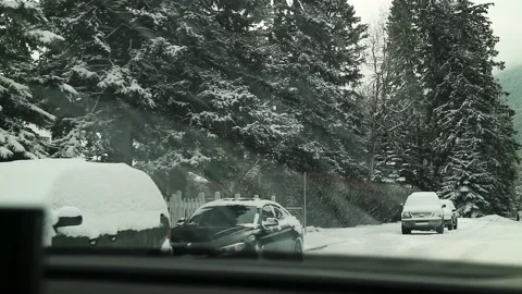 Car Driving In Small Town Covered In Snow 4K Banff Canada Stockbeeldmateriaal 239170939