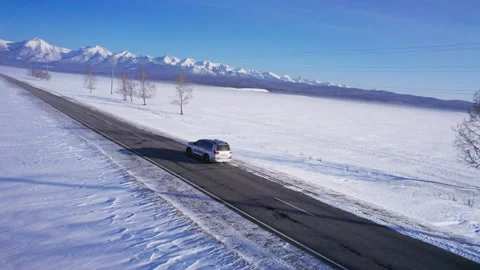 Car driving on a snow-covered road Stock Footage 282345157