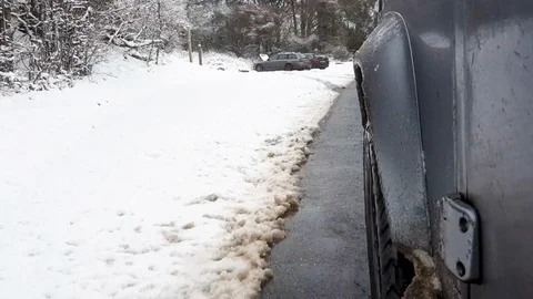 Car driving in snow side-on point of view shot Stock Footage 97153223