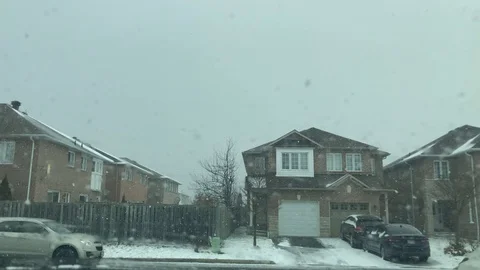 Car Driving By in Snowfall Stock Footage 126656959