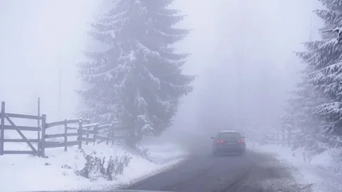 Car driving on a snowy road Stock Footage 83003185