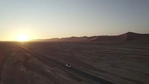 Car driving on Sossusvlei Road in Namibia on a sunset Stock Footage 264602137
