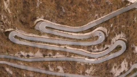 Car Driving on Steep Winding Mountain Road: Aerial View Stock Footage 308450116