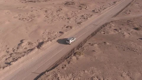 A car driving on a straight road then turning Stock Footage 139357953
