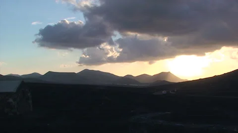 Car driving to the sunset in back lit volcanic landscape Stock Footage 51843080