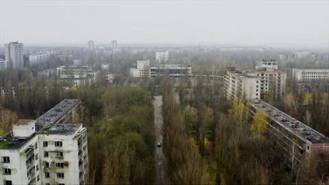 Car driving through abandoned ghost town of Pripyat Chernobyl Stock-Footage 332831406