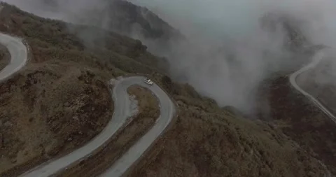 Car Driving Through Cloudy and Curvy Mountain Road Stock Footage 141247974