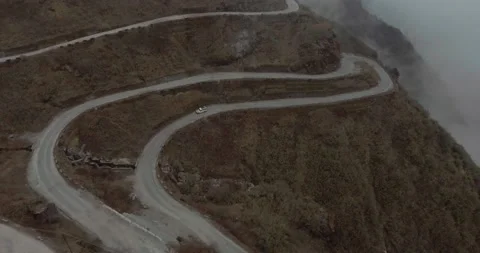 Car Driving Through Cloudy and Curvy Mountain Road Stock Footage 141248470