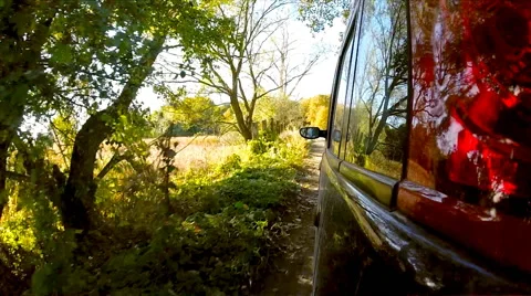 Car driving through the countryside. The camera is left outside. Stock Footage 44833102
