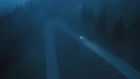 Car Driving Through Deep Fog on a Winding Road at Night Stock Footage 308451771