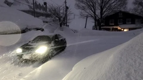 Car driving through deep heavy snow at night Stock Footage 259682084