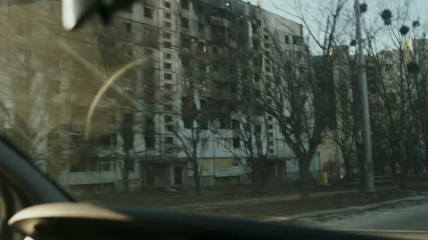 Car driving through the destroyed districts of Kharkiv Stock Footage 261470619