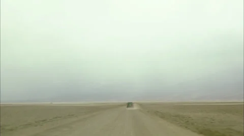 Car Driving Through Dirt Road at Death Valley, California HD Video Stock Footage 22690117