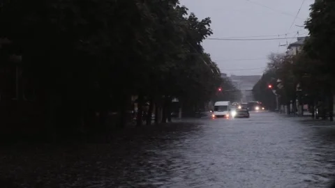 Car driving through a flooded street after the strong rain Stock Footage