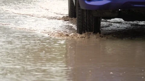 A car is driving through a flooded street Stock Footage 295205643