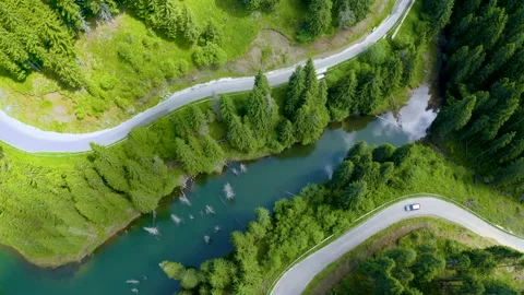 Car driving through the forest and the lake on the side. Beautiful mountain road Video stock 150589542