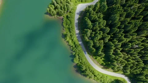 Car driving through the forest and the lake on the side. Beautiful mountain road 스톡 동영상 150589680