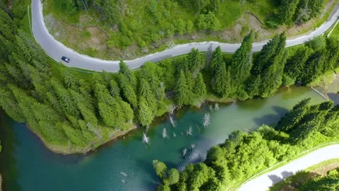 Car driving through the forest and the lake on the side. Beautiful mountain road Stock-Footage 150589759