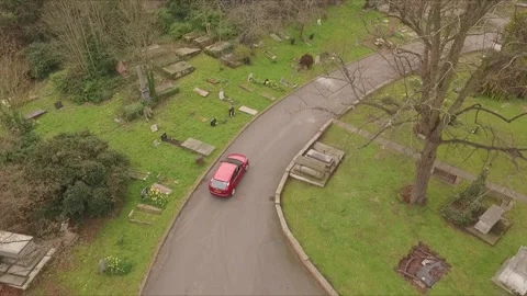 Car driving through graveyard Stock Footage 180560360