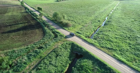 Car driving through green fields Stock Footage 94988832
