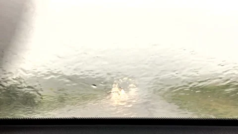 Car driving through heavy rain storm with water on windshield Stock Footage 130395796