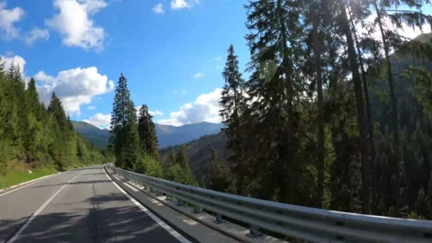 Car Driving Through Mountain Road On Sunny Day Stock Footage 150965886