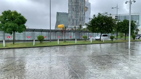 Car driving through a puddle in the rain, slow motion Stock Footage 162223459