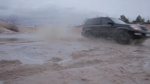 The car is driving through the sand Stock Footage 85927810