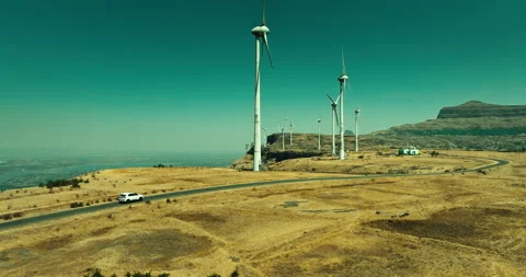 Car Driving Through Scenic Windmill Landscape Stockbeeldmateriaal 304105821