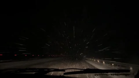 A car driving through snow storm at night down the empty road. Heavy snowstorm Stock Footage 270212061