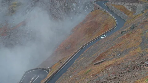 Car driving through the stelvio pass Stock Footage 169587987
