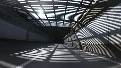 Car Driving Through a Tunnel with Light at the End, POV Stock Footage