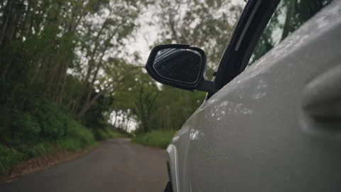 Car Driving Through Winding Roads in Lush Tropical Forest 4K Stock Footage 267048396