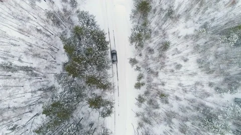 Car driving through the winter forest, aerial shot 動画素材 157306687