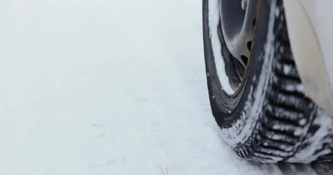 Car driving through a winter storm with snow on a forested road Stock Footage 101938224