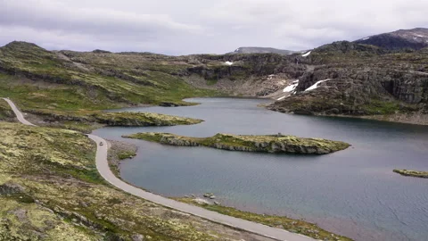 Car driving throught Norvegian severe Tundra nature with birdsyey top view Pictu Vídeo Stock 344353629