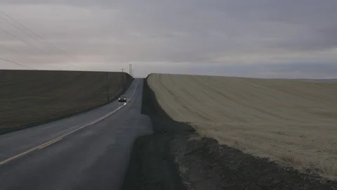 Car driving toward camera along rural highway, Oregon farmland Stock Footage 332084002