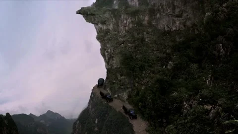 Car driving under the cliff Stock Footage 261632918