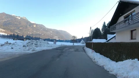 Car driving on wet road in small village Mojstrana. Stock Footage 169784398
