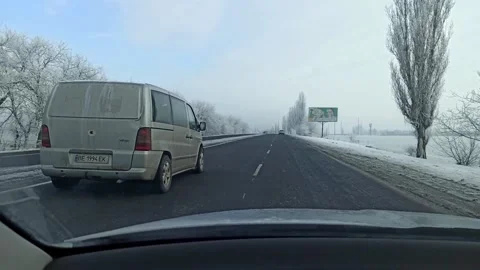 Car driving on a winter road Stock Footage 147861985