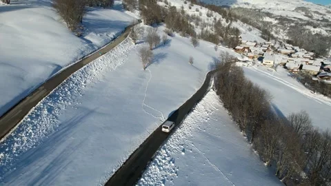 Car driving in a winter setting. lonely road with snowy trees Stock Footage 296638399