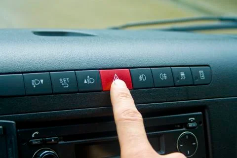 Car emergency button switch, finger press on button switch for turn on flashe Stock Photos